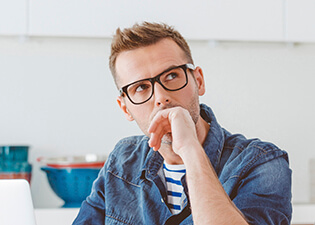 Young male patient with hand over mouth