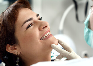 Young female patient smiling in dental chair