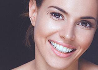 Young woman with natural-looking porcelain veneers