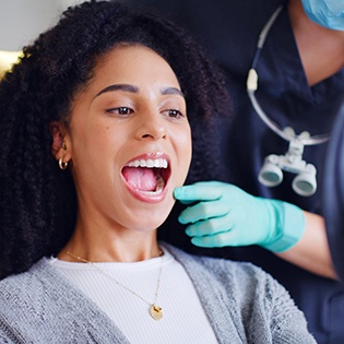 Patient looking at their new dental crown