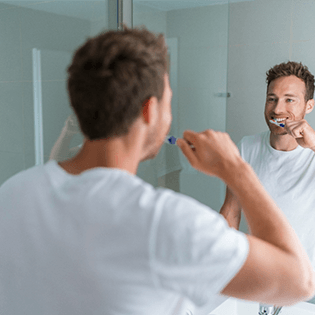 man brushing teeth