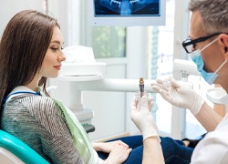 dentist explaining to patient how dental implants work in Marlton