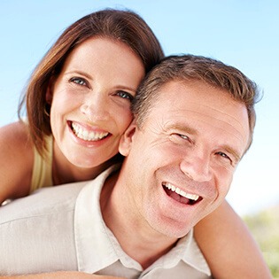 happy couple smiling with dental implants in Marlton