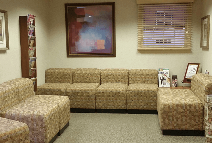 Comfortable couches and chairs in dental waiting area