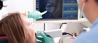 Dental patient and dentist examine x-ray