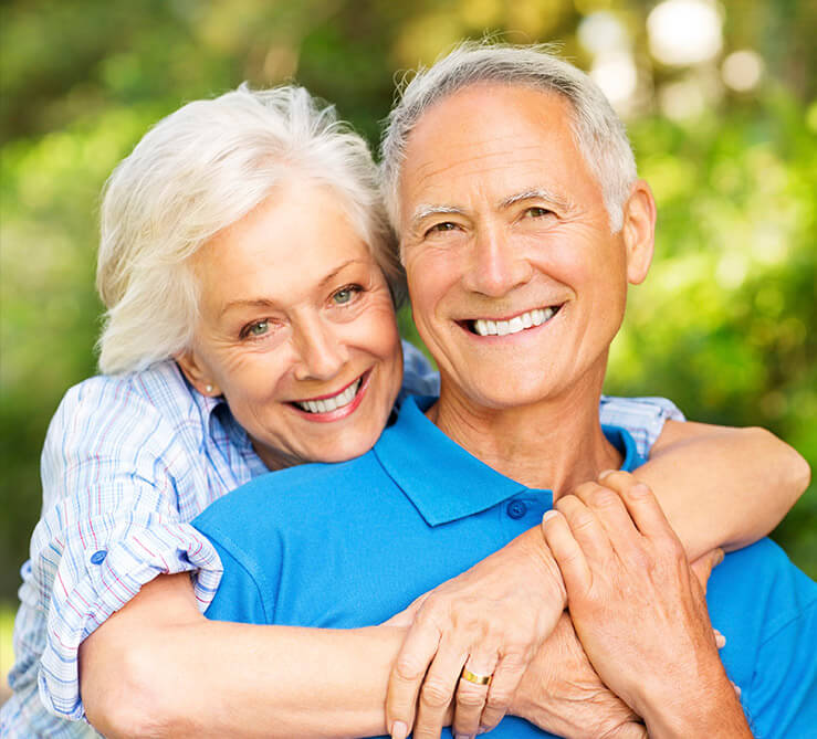 Older couple with healthy beautiful smiles