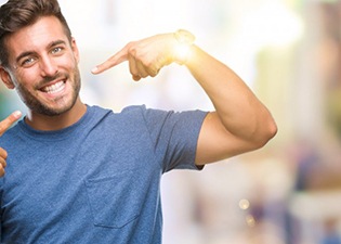 man pointing to his smile
