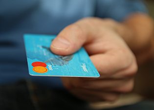Man extending debit card for payment