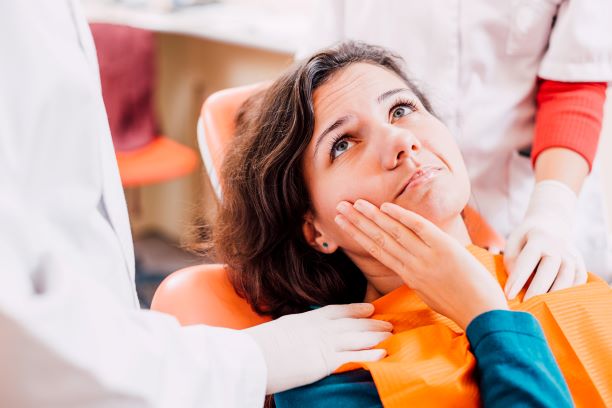 woman suffering from tooth pain