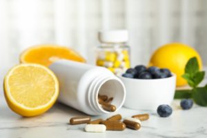 vitamins and healthy foods laying on a countertop