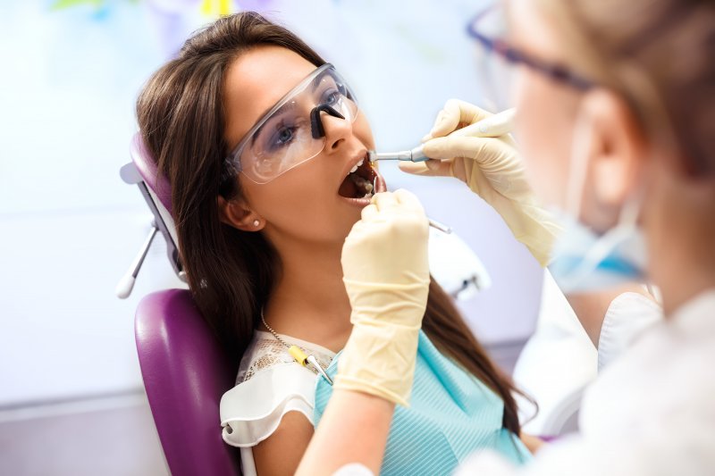 dentist examining patient’s mouth