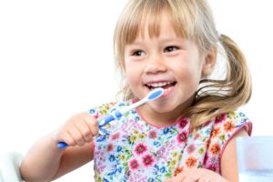 little girl brushing her teeth 