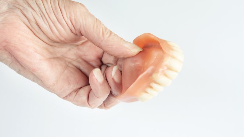 Patient holding prosthetic after denture relining