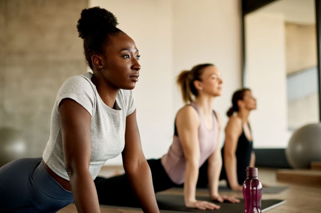 A group of women in a yoga class