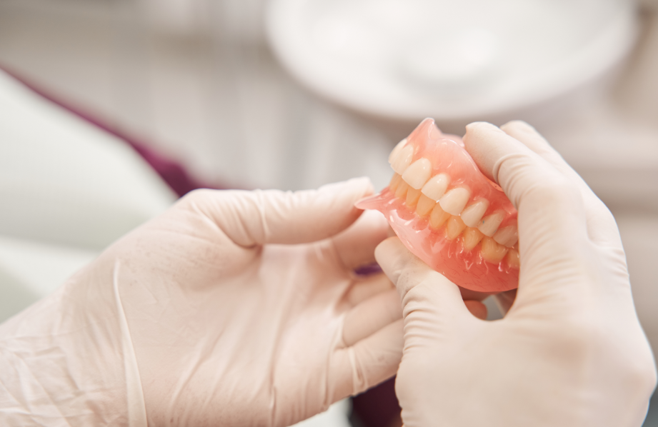 Close up of dentures in dentist's hand